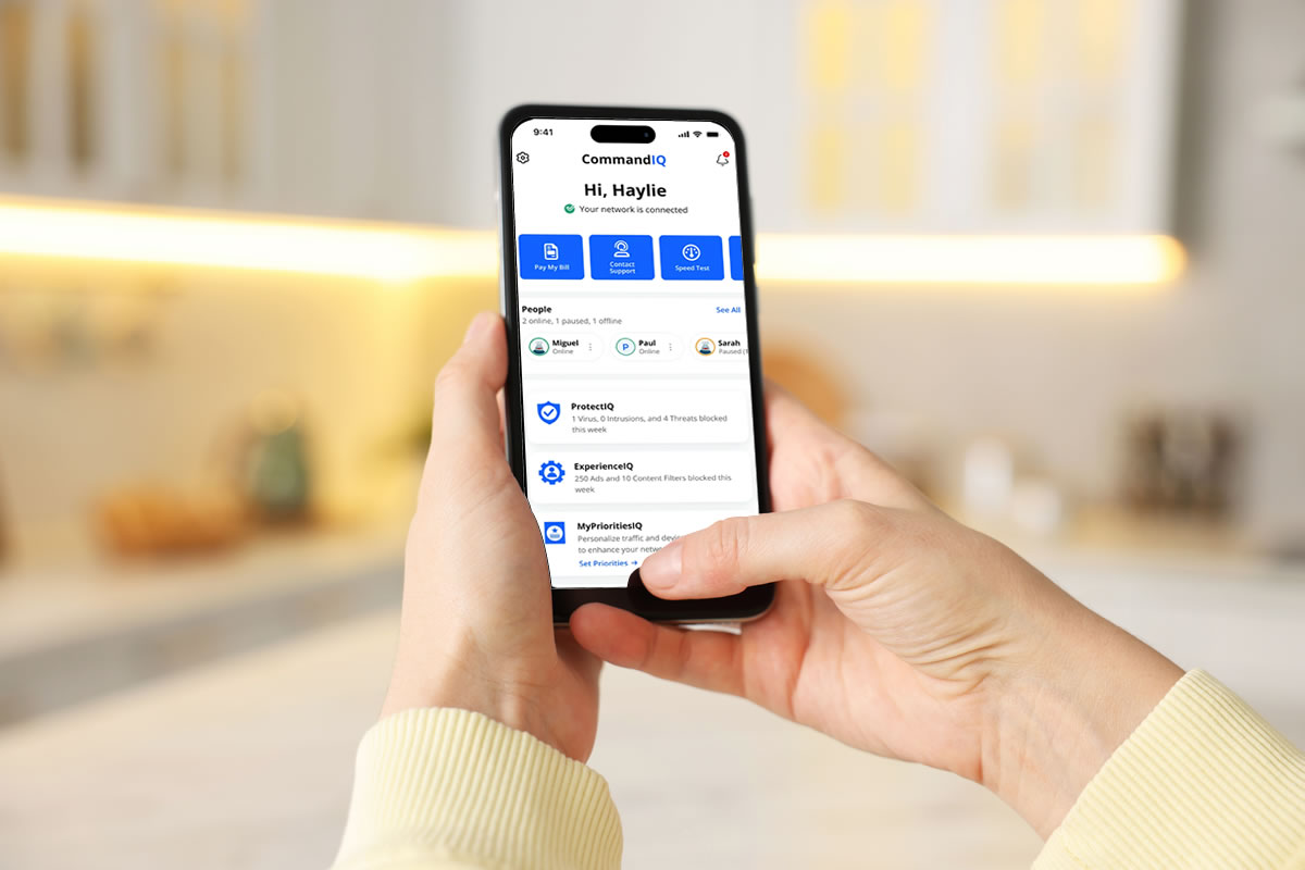 Phone-in-hand showing the CommandIQ dashboard